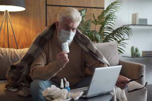 Elderly man getting online urgent care from a physician